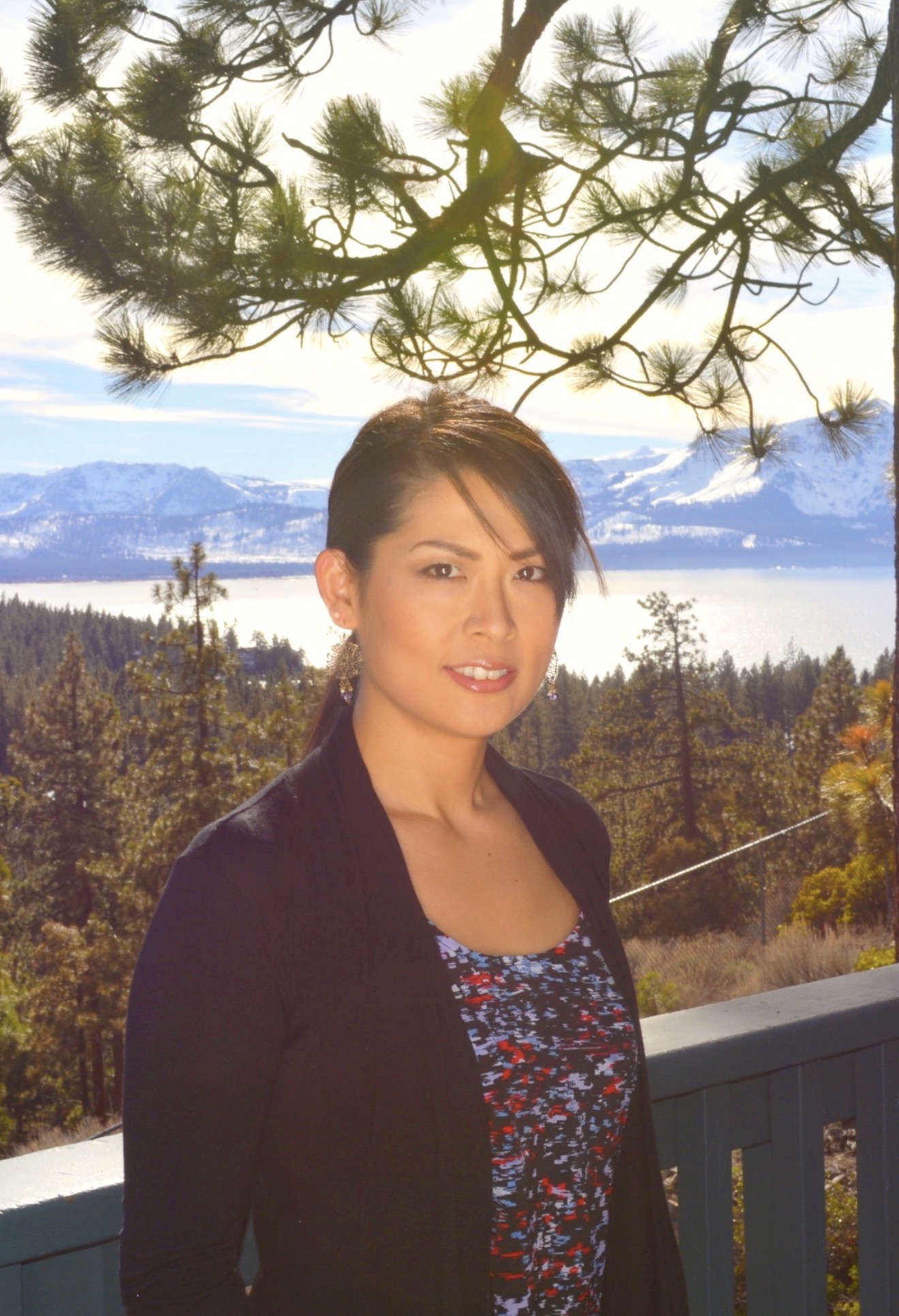 Ikumi outdoors overlooking Lake Tahoe and snow-covered mountains